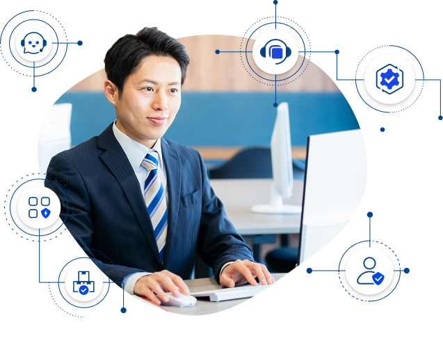 パソコンを使用するビジネスパーソンと周囲のデジタルサービスアイコンの写真。